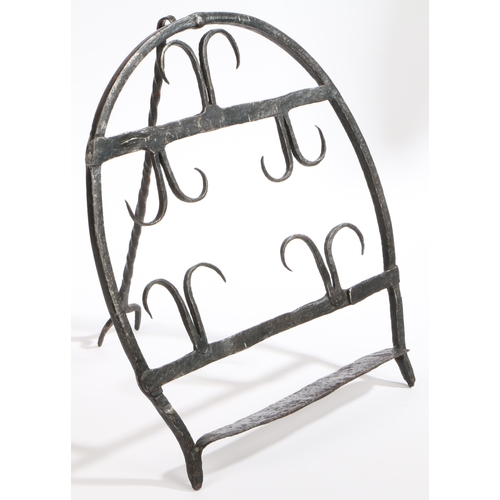 516 - A 19th century wrought iron bread warmer or hanan, Irish

 Of horseshoe design, with two rows of f... 