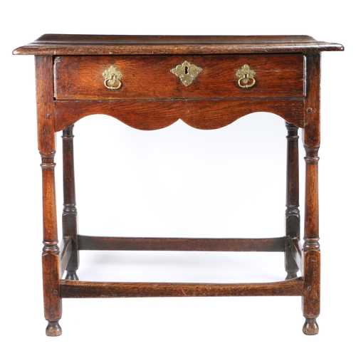 524 - A small George I oak side table, circa 1720

 The top of two boards with ovolo-moulded edge, single ... 