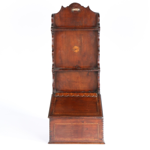 653 - A 19th century pine and inlaid spoon rack

 The slender one-piece backboard centre by an inlaid pate... 
