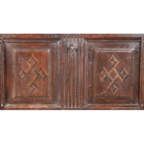 734 - An early 17th century oak and inlaid coffer, circa 1610

 The hinged lid with two fielded panels, th... 