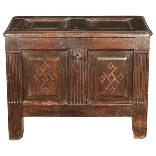 734 - An early 17th century oak and inlaid coffer, circa 1610

 The hinged lid with two fielded panels, th... 