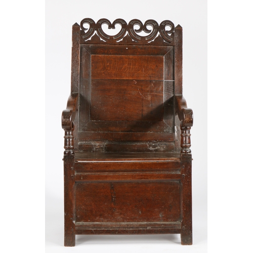 737 - A Charles II oak panel-back and box-seated open armchair, Cheshire, circa 1670

 Having a plain fiel... 