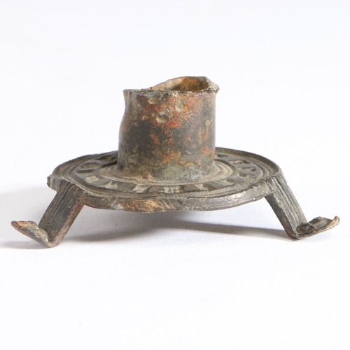 100 - A 14th century pewter votive candlestick

 Having a short cylindrical socket, on a flat circular bas... 