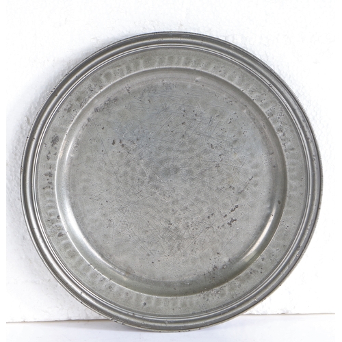 109 - A good Queen Anne pewter multiple-reeded rim and all-over hammered plate, circa 1706

 London label ... 