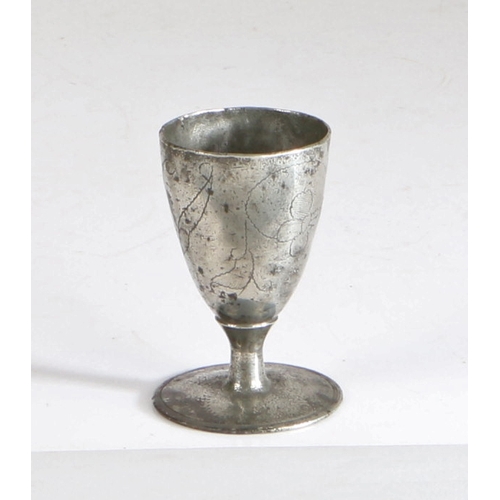 12 - A rare and documented Charles II pewter wrigglework footed wine' cup, circa 1680

 The conical egg-... 