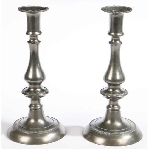 131 - A pair of George III pewter candlesticks, circa 1800

 Each of baluster-knopped form, with beaded de... 