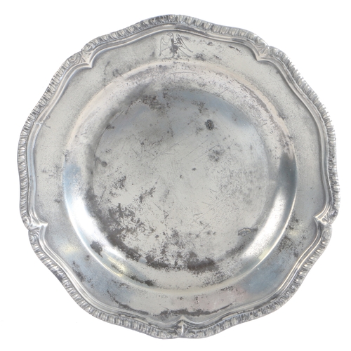 182 - A George II pewter five lobed wavy-edge plate, circa 1745

 The rim with a leafy-gadrooned and reede... 