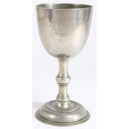 187 - An 18th century pewter communion cup

 Having a large plain bowl, a flattened-ball knop stem and dom... 