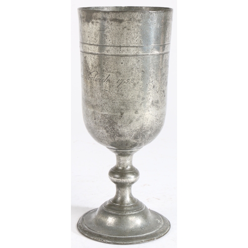 200 - An interesting George II pewter communion cup, dated 1758

 Having an unusually tall cup, with a hig... 