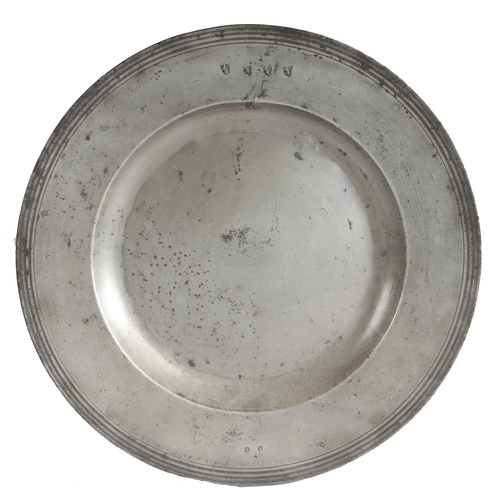 24 - A late 17th century pewter multiple-reeded broad rim charger, circa 1700

 The rim struck with four ... 