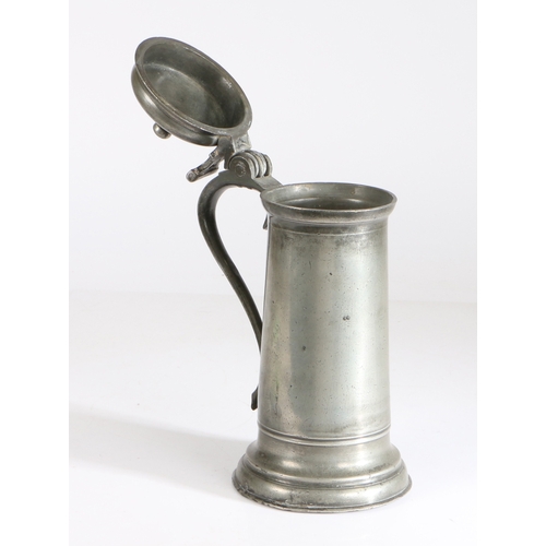 26 - A small Charles I pewter flagon, circa 1630

 Having a knopped bun lid, pierced-heart and bar thumbp... 