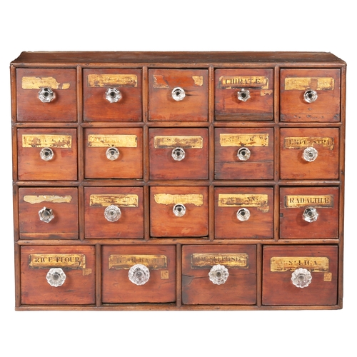 275 - A boarded and joined pine bank of nineteen small apothecary drawers, English, circa 1830-50

 The dr... 