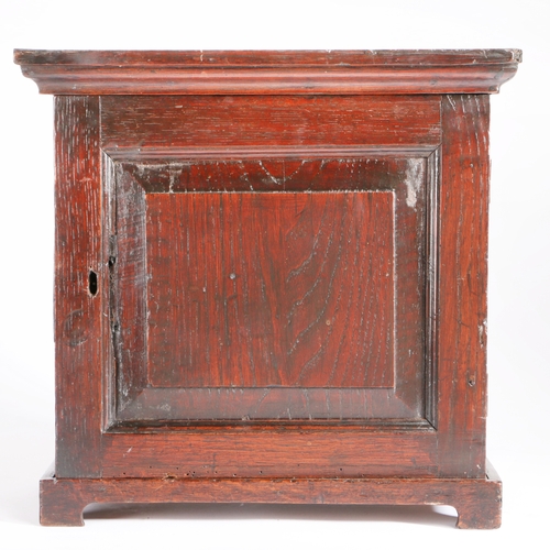 277 - An early 18th century table-top oak spice cupboard, circa 1710-30

 Having a fielded panelled cupboa... 