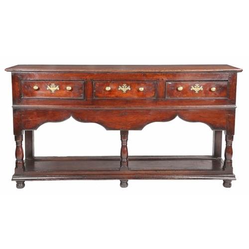 283 - A George II oak open dresser base, Montgomeryshire, circa 1740

 Having a boarded top, and three coc... 