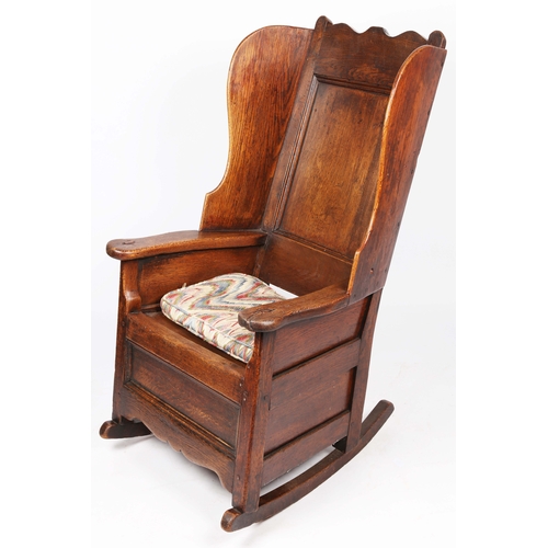 297 - A George I/II oak winged armchair, Welsh, circa 1720-40

 Having a rectangular fielded back with bea... 