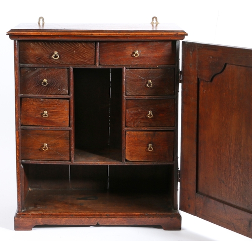 313 - A George II oak table-top spice cupboard, circa 1750 and later

 Having a flattened-ogee arched fiel... 