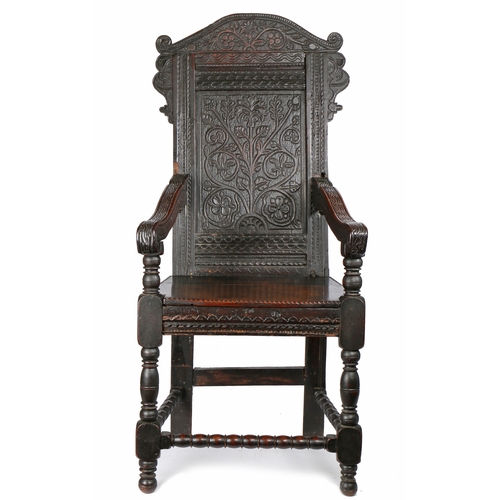 314 - A Charles II oak open armchair, circa 1660 and later

 The back panel carved with a single flowering... 