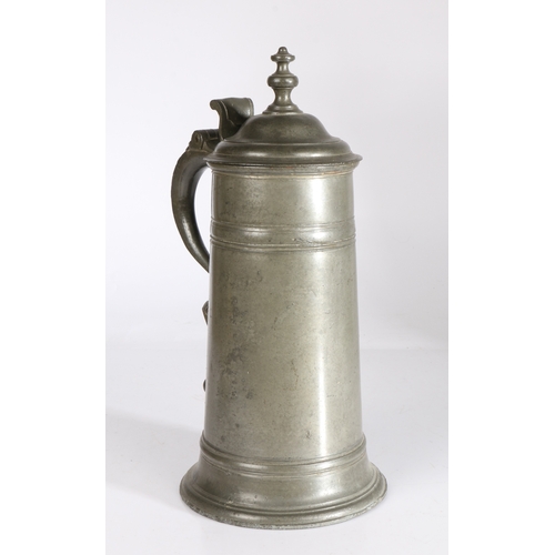 32 - A George I/II pewter spire flagon, circa 1720-50

 Having a straight-sided tapering drum with broad ... 