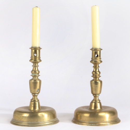 321 - A pair of 18th century brass candlesticks, Spanish

 Each with a moulded straight-sided socket, a ba... 