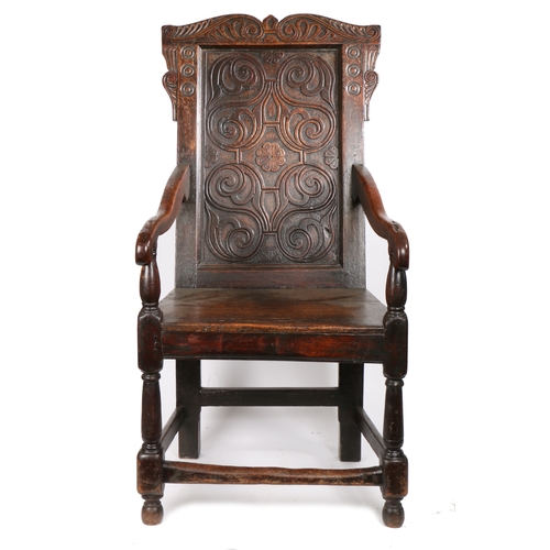 344 - A Charles II oak open armchair, circa 1660 and later

 The back panel relief carved with strap-work ... 