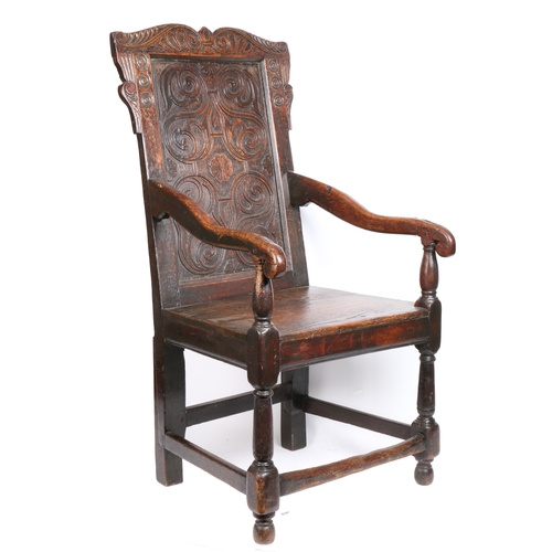 344 - A Charles II oak open armchair, circa 1660 and later

 The back panel relief carved with strap-work ... 