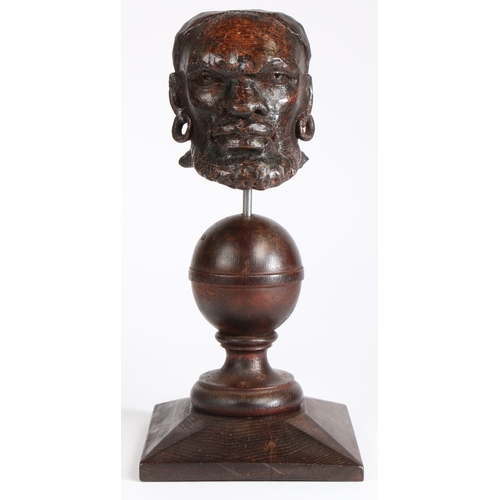 352 - An early 17th century carved oak African male head mount, English, circa 1600-20

 Designed with loo... 