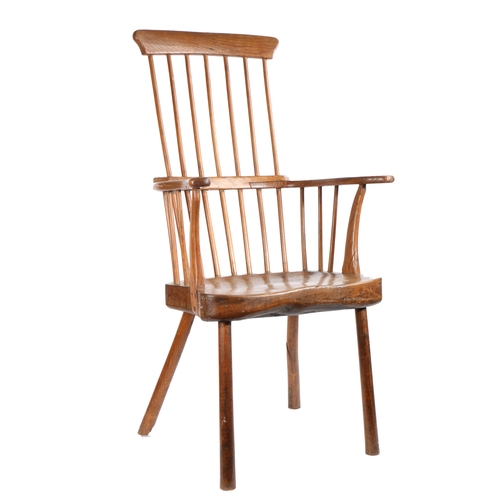 372 - A George III ash comb-back primitive Windsor armchair, West Country, circa 1800

 The tall back of s... 