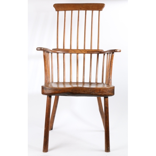 372 - A George III ash comb-back primitive Windsor armchair, West Country, circa 1800

 The tall back of s... 