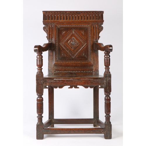 374 - An Elizabeth I joined oak panel-back open armchair, West Country, circa 1600

 The back panel carved... 