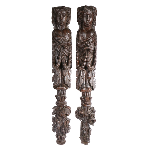 376 - A large and impressive pair of 17th century oak figural terms

 Each carved as a female, with elonga... 