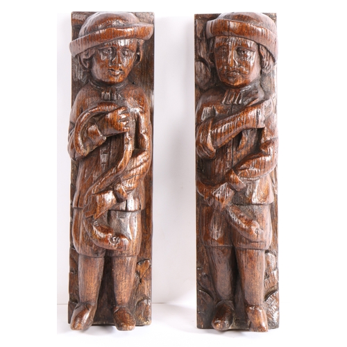 377 - An unusual pair of oak carved figural terms, Flemish, circa 1600

 Each designed as a male, with lon... 