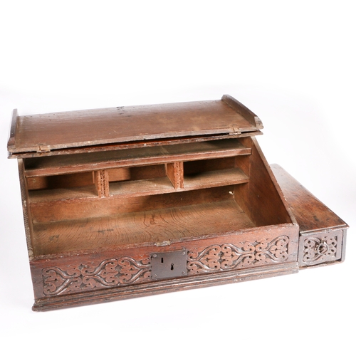 395 - An early 17th century boarded oak desk box, English, circa 1600-30

 Having a one-piece sloping lid ... 