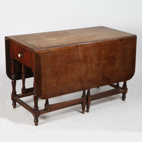 396 - A George II mahogany gateleg dining table

 The rectangular top with two drop leaves, above a drawer... 