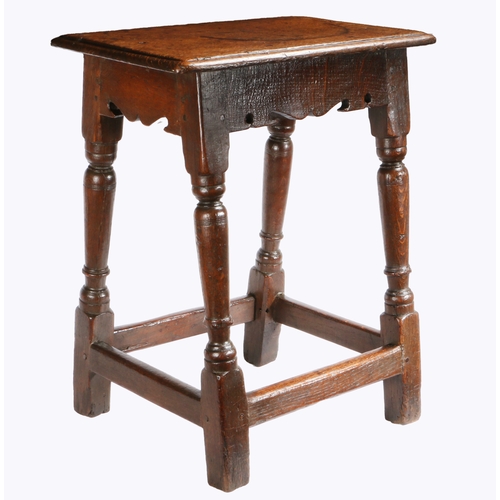 397 - A Charles I oak joint stool, circa 1640

 Having an ovolo-moulded top, bicuspid-shaped rails, on bal... 