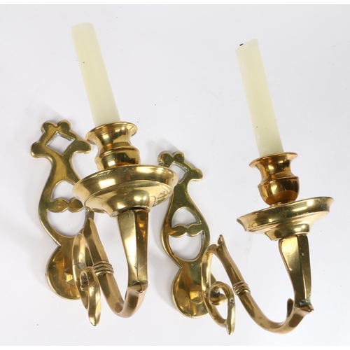 415 - A pair of cast brass wall sconces, 18th century and later

 Each with a shaped and pierced backplate... 