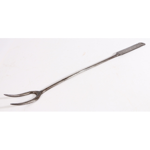 417 - A George II iron meat fork, circa 1750

 With two tines, plain stem and flattened handle with decora... 