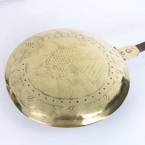 442 - An interesting early 17th century brass and iron warming pan, English

 The circular domed lid  with... 