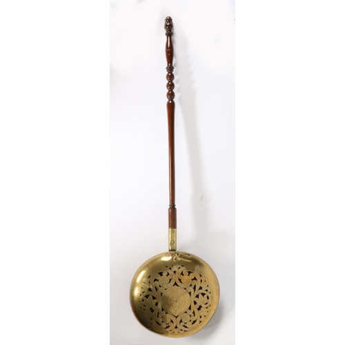 443 - An early 18th century brass and oak warming pan, Dutch

 Having a domed, floral pierced and engraved... 