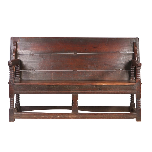 450 - A Charles II oak table-settle, circa 1680

 Having a boarded and end-cleated back/top, on four ball-... 