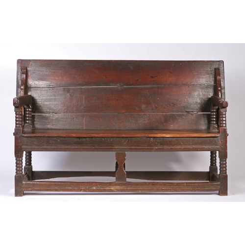 450 - A Charles II oak table-settle, circa 1680

 Having a boarded and end-cleated back/top, on four ball-... 