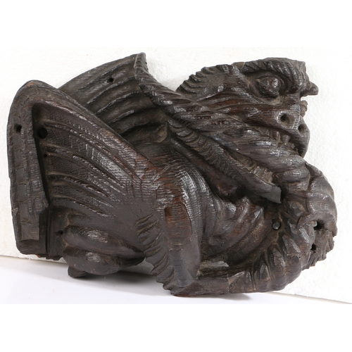 458 - A rare 15th century oak dragon-carved boss, English, circa 1400

 The snarling, winged beast clenchi... 