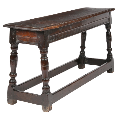 513 - A James I oak bench or form, circa 1620

 The one-piece top with ovolo-moulded edge, the rails with ... 