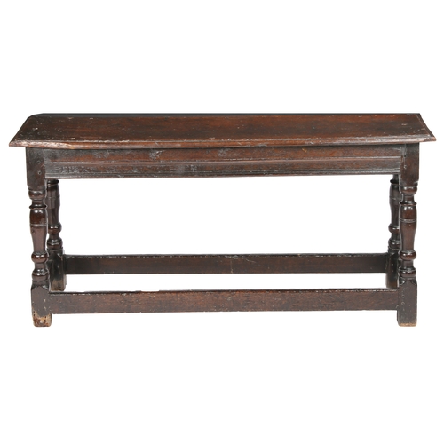 513 - A James I oak bench or form, circa 1620

 The one-piece top with ovolo-moulded edge, the rails with ... 