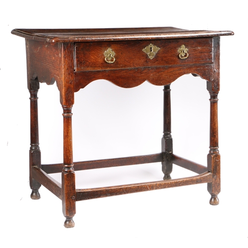 524 - A small George I oak side table, circa 1720

 The top of two boards with ovolo-moulded edge, single ... 