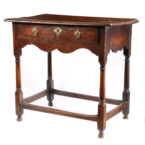 524 - A small George I oak side table, circa 1720

 The top of two boards with ovolo-moulded edge, single ... 