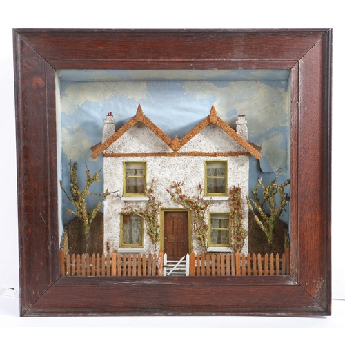 711 - A Victorian cased diorama, depicting a house, circa 1870

 The twin-gabled house with cork roof and ... 