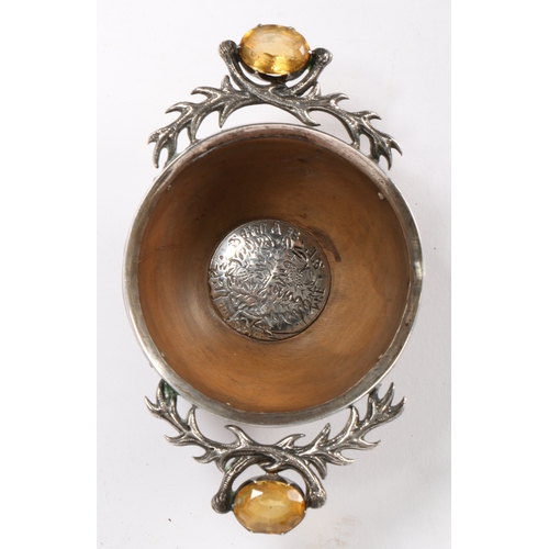 718 - A 19th century Scottish quaich

 With two handles, each set with a cairngorm within white metal cros... 