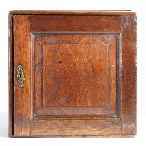 727 - A small William & Mary oak spice cupboard, circa 1700

 Having a fielded panelled door, enclosing an... 