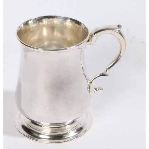 32 - A George II silver mug, Newcastle 1753, maker Isaac Cookson, with double scroll handle to the taperi... 