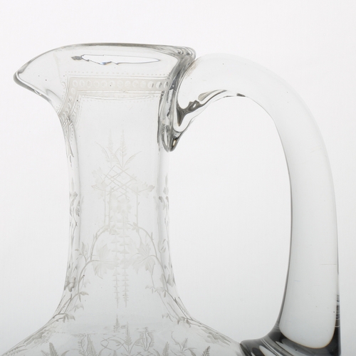 54 - A Victorian English glass claret jug, possibly by Thomas Webb, finely engraved with leaves and star ... 